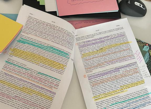 Paper with comments and colored lines on the table